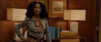 Movie still from “Anchorman 2: The Legend Continues” (2013), directed by Adam McKay – A woman standing in front of a bookshelf in an office; Medium shot, Low angle