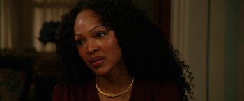 Movie still from “Anchorman 2: The Legend Continues” (2013), directed by Adam McKay – A person wearing a necklace; Close Up shot, Over the shoulder angle