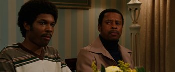 Movie still from “Anchorman 2: The Legend Continues” (2013), directed by Adam McKay – A man and a woman sitting in front of a table; Close Up shot, Over the shoulder angle