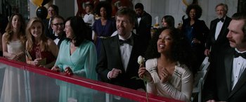 Movie still from “Anchorman 2: The Legend Continues” (2013), directed by Adam McKay – A group of people standing in a room; Medium shot, Over the shoulder angle