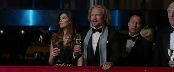 Movie still from “Anchorman 2: The Legend Continues” (2013), directed by Adam McKay – A man and a woman are holding wine glasses; Medium shot, Low angle