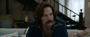 Movie still from “Anchorman 2: The Legend Continues” (2013), directed by Adam McKay – A person with a mustache wearing a jacket; Close Up shot, Low angle