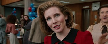 Movie still from “Anchorman 2: The Legend Continues” (2013), directed by Adam McKay – A person wearing a red dress; Close Up shot, Over the shoulder angle
