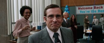Movie still from “Anchorman 2: The Legend Continues” (2013), directed by Adam McKay – A person wearing a suit and tie; Close Up shot, Over the shoulder angle