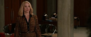 Movie still from “Anchorman 2: The Legend Continues” (2013), directed by Adam McKay – A woman standing in front of a wall in a room; Medium shot, Over the shoulder angle