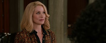 Movie still from “Anchorman 2: The Legend Continues” (2013), directed by Adam McKay – A woman with blonde hair wearing a black and red shirt; Close Up shot, Over the shoulder angle