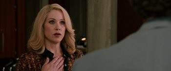 Movie still from “Anchorman 2: The Legend Continues” (2013), directed by Adam McKay – A woman with blonde hair is standing in front of a mirror; Close Up shot, Over the shoulder angle