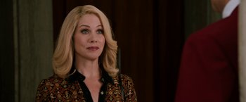 Movie still from “Anchorman 2: The Legend Continues” (2013), directed by Adam McKay – A woman with blonde hair wearing a black and red shirt; Close Up shot, Over the shoulder angle