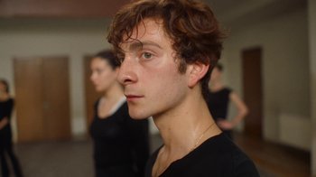 Movie still from “And Then We Danced” (2019), directed by Levan Akin – A young man is looking into the distance; Close Up shot, Low angle