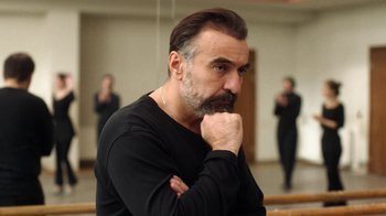 Movie still from “And Then We Danced” (2019), directed by Levan Akin – A man in a black shirt is posing for a picture; Close Up shot, Low angle