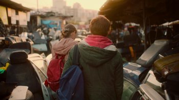 Movie still from “And Then We Danced” (2019), directed by Levan Akin – A man and a woman are walking through a crowded area; Medium shot, Over the shoulder angle