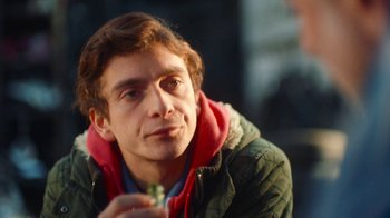 Movie still from “And Then We Danced” (2019), directed by Levan Akin – A person wearing a jacket; Close Up shot, Over the shoulder angle