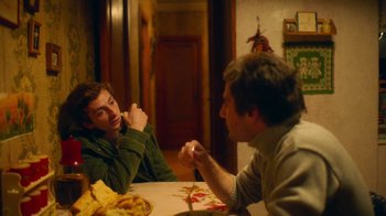 Movie still from “And Then We Danced” (2019), directed by Levan Akin – Two men are sitting at a table eating pizza; Medium shot, Over the shoulder angle
