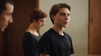 Movie still from “And Then We Danced” (2019), directed by Levan Akin – A young man standing in front of a mirror in front of a wall; Close Up shot, Over the shoulder angle