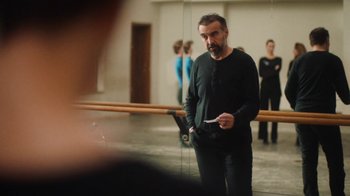 Movie still from “And Then We Danced” (2019), directed by Levan Akin – A man standing next to a mirror in a room; Medium shot, Over the shoulder angle