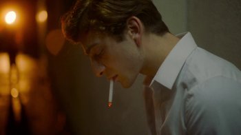 Movie still from “And Then We Danced” (2019), directed by Levan Akin – A young man smoking a cigarette in a room; Close Up shot, Low angle