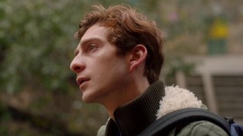 Movie still from “And Then We Danced” (2019), directed by Levan Akin – A young man with brown curly hair wearing a jacket; Close Up shot, Low angle