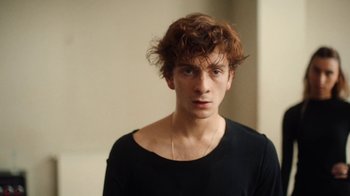 Movie still from “And Then We Danced” (2019), directed by Levan Akin – A young man in a black t - shirt is posing for a picture; Close Up shot, Low angle