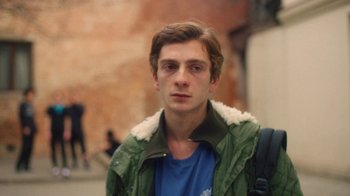 Movie still from “And Then We Danced” (2019), directed by Levan Akin – A young man in a green jacket and blue shirt; Close Up shot, Low angle