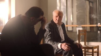 Movie still from “And Then We Danced” (2019), directed by Levan Akin – An older man sitting next to a younger man; Medium shot, Over the shoulder angle