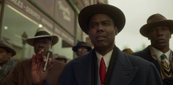 Movie still from “Fargo” (2014), created by Noah Hawley – A man in a suit and a red tie holding a cell phone; Close Up shot, Low angle