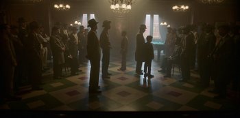 Movie still from “Fargo” (2014), created by Noah Hawley – A group of people standing in a room; Wide shot, High angle