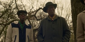 Movie still from “Fargo” (2014), created by Noah Hawley – A couple of men standing next to each other in a park; Medium shot, Low angle