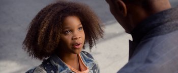 Movie still from “Annie” (2014), directed by Will Gluck – A little girl with blue eyes looking at the camera; Close Up shot, Over the shoulder angle