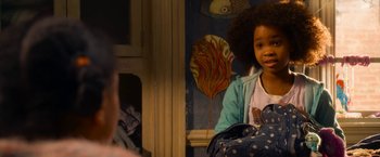 Movie still from “Annie” (2014), directed by Will Gluck – A little girl sitting in front of a painting; Close Up shot, Over the shoulder angle