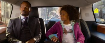 Movie still from “Annie” (2014), directed by Will Gluck – A man and a little girl sitting in the back of a car; Medium shot, Over the shoulder angle