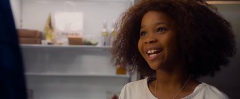 Movie still from “Annie” (2014), directed by Will Gluck – A young girl smiling with her mouth wide open; Close Up shot, Over the shoulder angle