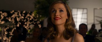 Movie still from “Annie” (2014), directed by Will Gluck – A woman with red lipstick looking to her left; Close Up shot, Over the shoulder angle
