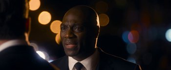 Movie still from “Annie” (2014), directed by Will Gluck – A person wearing a suit and tie; Close Up shot, Over the shoulder angle