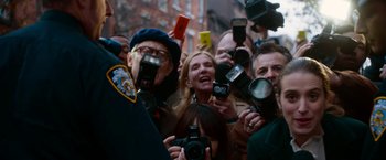 Movie still from “Annie” (2014), directed by Will Gluck – A group of people taking pictures with cameras; Medium shot, Over the shoulder angle