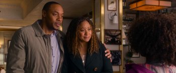 Movie still from “Annie” (2014), directed by Will Gluck – A man and a woman standing next to each other in a room; Medium shot, High angle