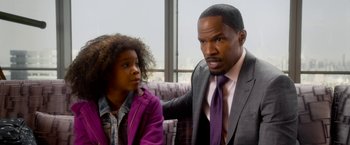 Movie still from “Annie” (2014), directed by Will Gluck – A man in a suit and a girl in a purple jacket; Close Up shot, Over the shoulder angle