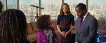 Movie still from “Annie” (2014), directed by Will Gluck – Two young women standing in front of a large window; Medium shot, Over the shoulder angle