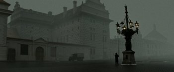 Two people standing on a street corner in front of a building