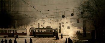 People are walking on the street near a train