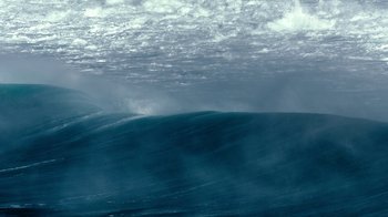 A large body of water under a cloudy blue sky