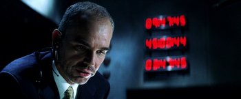 Movie still from “Armageddon” (1998), directed by Michael Bay – A person wearing a suit and tie; Close Up shot, Low angle