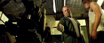 Movie still from “Armageddon” (1998), directed by Michael Bay – A man standing in front of an open umbrella; Medium shot, Low angle