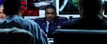 Movie still from “Armageddon” (1998), directed by Michael Bay – An air force officer sitting in front of a computer screen; Close Up shot, Over the shoulder angle