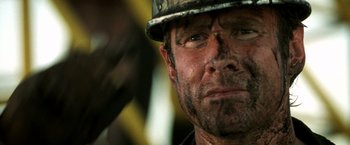 Movie still from “Armageddon” (1998), directed by Michael Bay – A person wearing a hard hat; Close Up shot, Over the shoulder angle