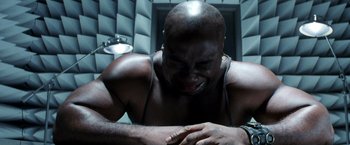 Movie still from “Armageddon” (1998), directed by Michael Bay – A man with a black shirt is looking down; Close Up shot, Overhead angle