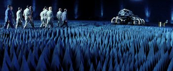 Movie still from “Armageddon” (1998), directed by Michael Bay – A group of people standing in a field of blue paper; Extreme Wide shot, High angle