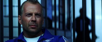 Movie still from “Armageddon” (1998), directed by Michael Bay – A person wearing a blue jacket; Close Up shot, Low angle