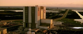 Movie still from “Armageddon” (1998), directed by Michael Bay – An aerial view of a building with a flag on it; Extreme Wide shot, High angle