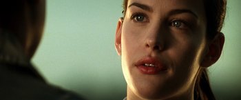 Movie still from “Armageddon” (1998), directed by Michael Bay – A person's face with green eyes; Close Up shot, Over the shoulder angle