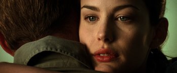 Movie still from “Armageddon” (1998), directed by Michael Bay – A woman's face in a dark room; Extreme Close Up shot, Over the shoulder angle